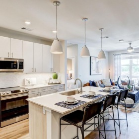 Spacious kitchens with thoughtful details a kitchen with a dining table and chairs